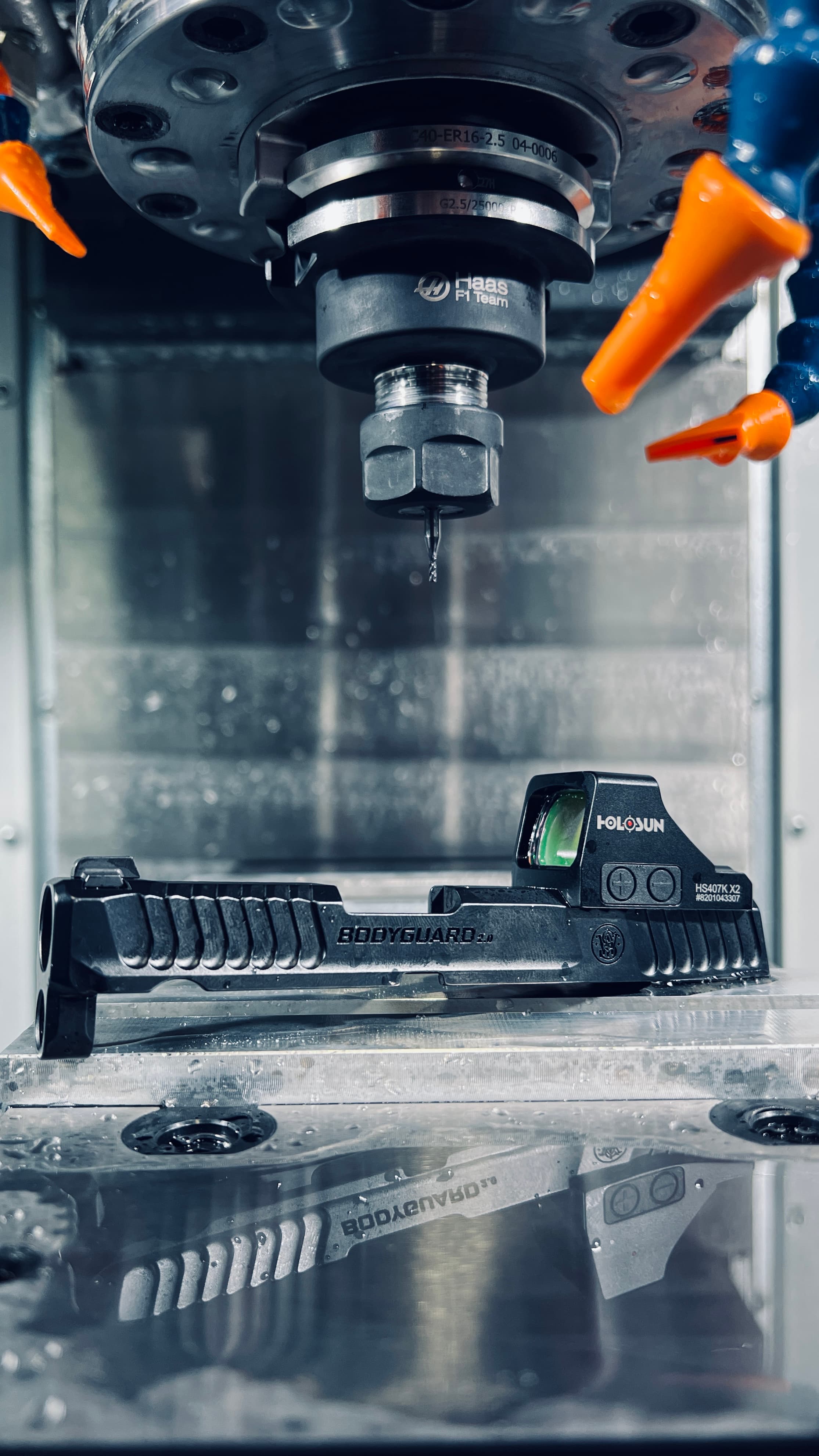 CNC machine milling a pistol slide
